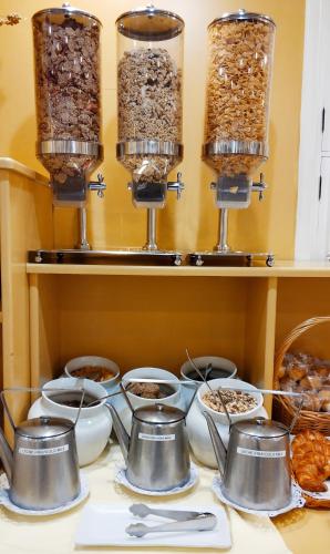 a table topped with pots and bowls of food at Hotel Don Paco in Seville