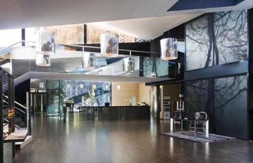 a lobby of a building with a table and lights at Eurostars Palace in Córdoba