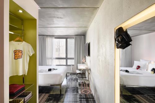 a bathroom with two sinks and two white baths at Mama Shelter Marseille in Marseille