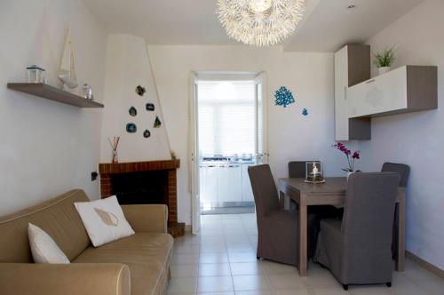 a living room with a couch and a dining room table at case per vacanze torre incina in Polignano a Mare