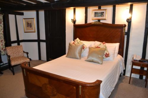 a bedroom with a bed with white sheets and pillows at Mermaid Inn in Rye