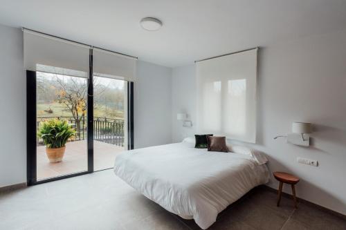 a bedroom with a large bed and a large window at Mirador Ardea Mendixur in Mendijur