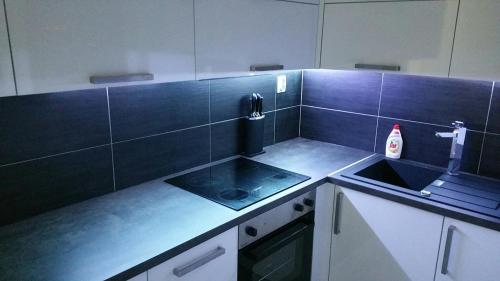 a kitchen with a sink and a counter top at Byt v centre mesta Martin in Martin