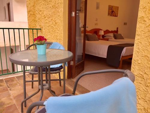 a table and chairs in a room with two beds at Sol y Luna Cala Millor in Cala Millor