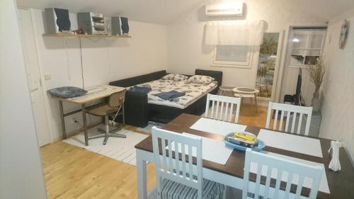 a living room with a table and a dining room at Arctic River Apartment in Rovaniemi