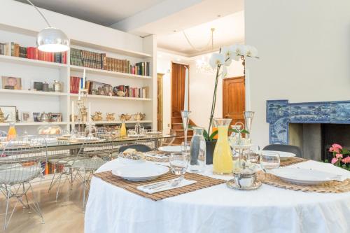 a dining room with a table with plates and glasses at Cristina Rossi Bed&Breakfast in Bologna