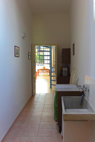 a kitchen with a sink and a door to a patio at Casa Le Pigne in Avola