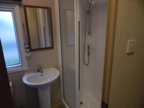 a bathroom with a sink and a shower at Flamingo Land - Woodlands W42 in Kirby Misperton