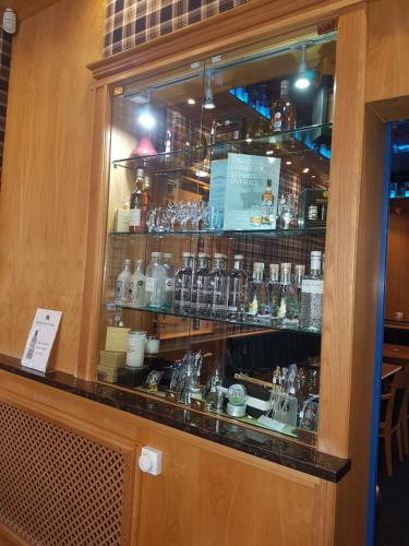 a display window of a bar with many glasses at Ardshiel Hotel in Campbeltown