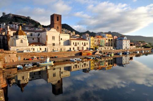 a city with a reflection in a body of water at Casa Oleandri in Tresnuraghes