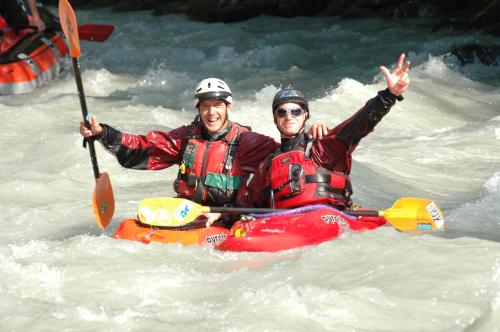 two people in a raft in a river at Altogold Swiss Holidays At Manor Farm 5* in Interlaken