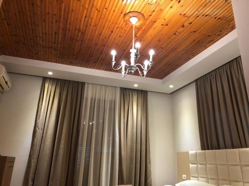 a chandelier hanging from a ceiling in a room at Hotel Lungomare in Vlorë