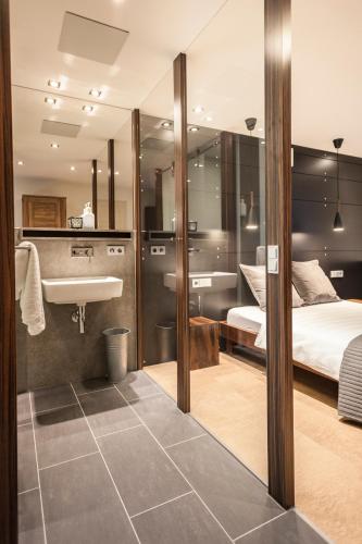 a bathroom with a bed and a sink in a room at Zum Sonnenwirt in Bopfingen