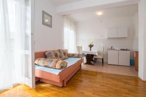 a living room with a couch and a kitchen at Apartments Zeljko in Makarska