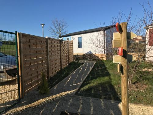 a fence with a gate and a fence at CosyStudio Site du Futuroscope in Chasseneuil-du-Poitou