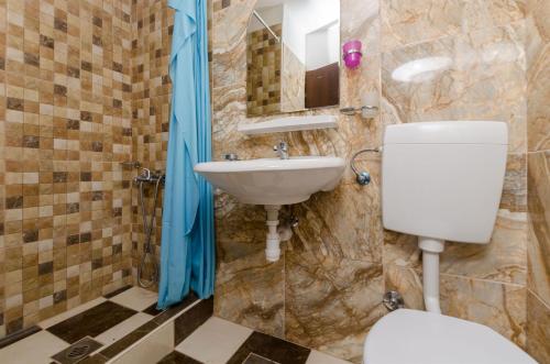 a bathroom with a toilet and a sink at Apartment Barba in Rogač
