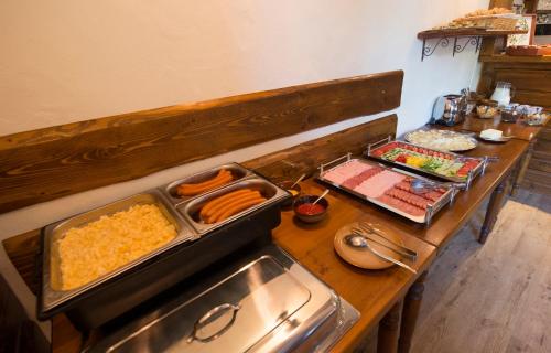 a table with many different types of food on it at Chata Piecky in Hrabušice