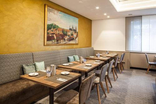 a dining room with wooden tables and chairs at Hotel am Dom in Fulda