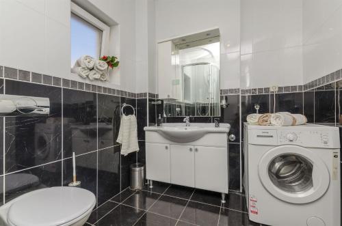 a bathroom with a washing machine and a sink at Apartments Mare in Postira