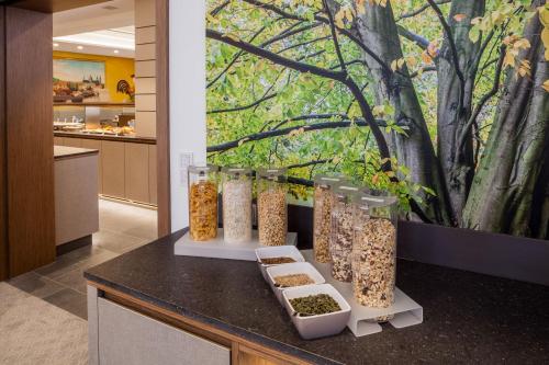 a counter with several glass jars of food at Hotel am Dom in Fulda