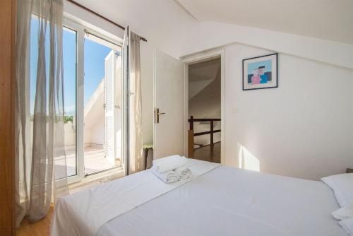 Postel nebo postele na pokoji v ubytování Apartments Antonija