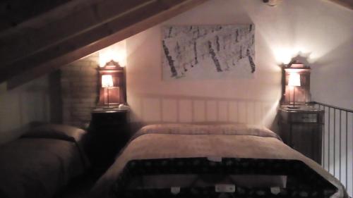 a bedroom with a bed with two lamps on it at Valli Unite in Costa Vescovato
