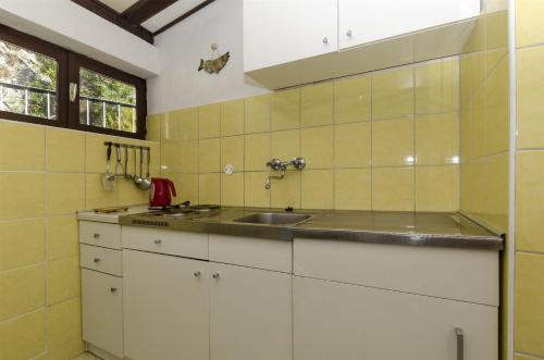 een keuken met witte kasten en een spoelbak bij Apartment Boris in Gornja Brela