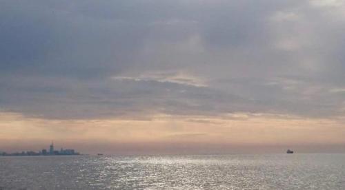 a large body of water with a city in the distance at Ana's Apartment in Chakvi Oasis in Chakvi