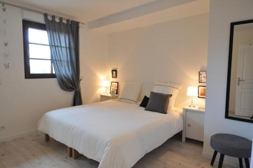 une chambre avec un grand lit blanc et une fenêtre dans l'établissement Logis Du Haut-Koenigsbourg, à Thannenkirch