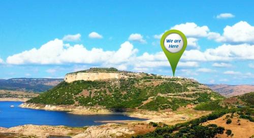 a green balloon with a sign that says we are here at Brancadoria B&B in Monteleone Rocca Doria