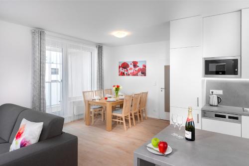a living room with a table and a dining room at CityWest Apartments in Prague