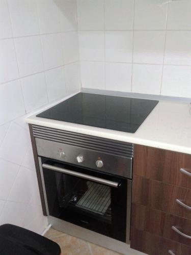 a kitchen with an oven with a counter top at Casa Neuza in Fuzeta