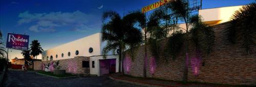 a building with a palm tree in front of it at Rhodes Hotel Recife in Recife