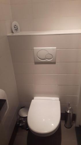 a bathroom with a white toilet in a room at Picco Bello in Zandvoort