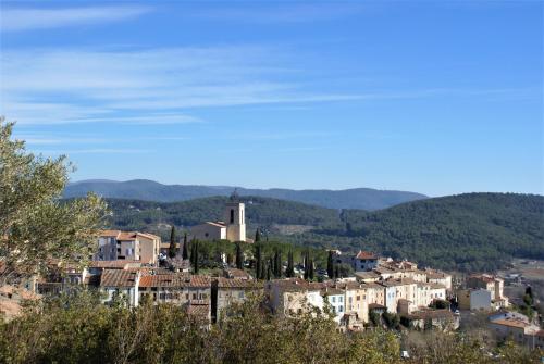 a town on a hill with trees and buildings at La Villa Aux Oliviers in Flayosc