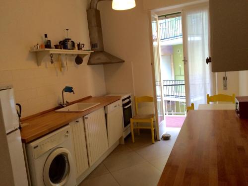 a kitchen with a sink and a washing machine at Casa Liliana in Levanto