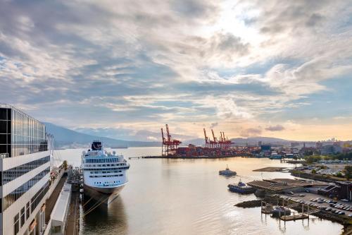 a cruise ship is docked in a harbor at Fairmont Waterfront in Vancouver