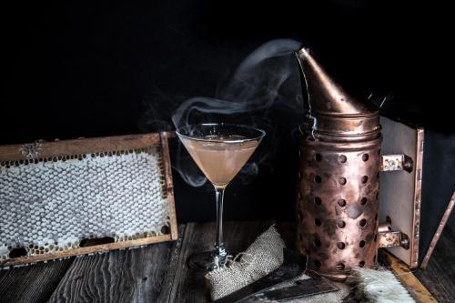 a smoking drink in a glass next to an oldasket at Fairmont Waterfront in Vancouver