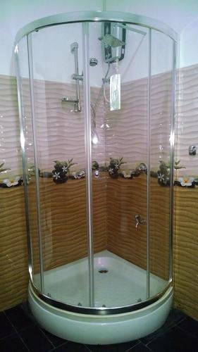 a shower with a glass enclosure in a bathroom at Kings Village Sigiriya in Sigiriya
