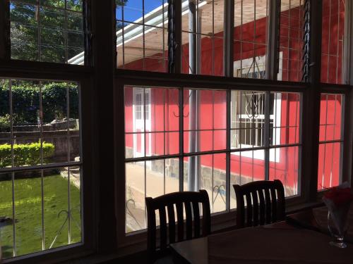 a view from a window of a red building at Hotel Hacienda El Rodeo in Rodeo