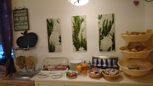 a table with food and baskets on the wall at Pension Bergblick in Ruhpolding