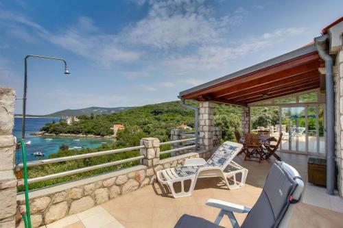 a patio with chairs and a view of the water at House Nevenka in Štivan