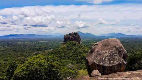 a view of a mountain with two large rocks at Kings Village Sigiriya in Sigiriya