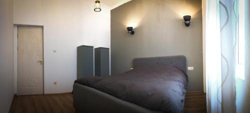 a bedroom with a bed in the corner of a room at The Dutchies' apartment in Plovdiv