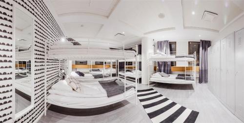 a room with four bunk beds in it at Hostel Café Koti in Rovaniemi