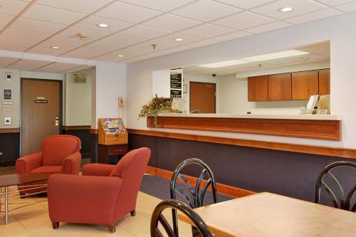 a waiting room at a hospital with desks and chairs at Super 8 by Wyndham Manchester Airport in Manchester