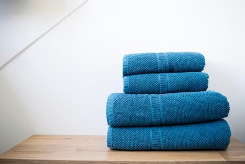 a stack of blue towels sitting on a table at B&B De Hanewijkhoeve in Werchter
