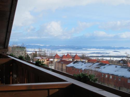 a view of a city with snow covered roofs at Podkrovný apartmán v Smokovec in Smokovce