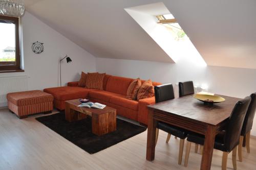 a living room with a couch and a table at Podkrovný apartmán v Smokovec in Smokovce