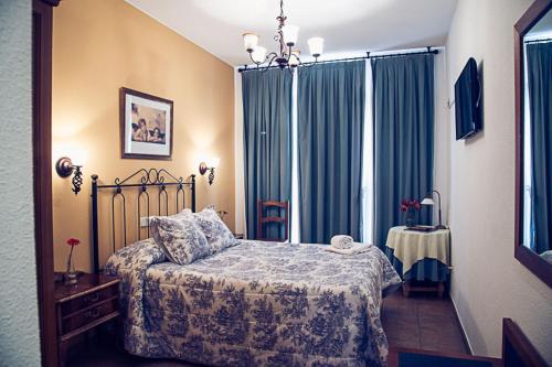 A bed or beds in a room at Hostal Goya II